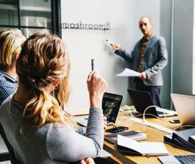 Colleagues presenting in an office